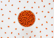Sea buckthorn berries in bowl on white background. Top view. Selective focus. Orange berries of Hippophae plant. 