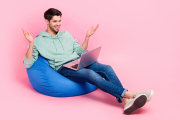 Fototapete - Full length photo of nice stylish boy sit comfort chair look webcamera chatting friends empty space isolated on pink color background