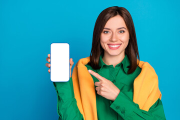 Sticker - Photo of attractive cheerful lady indicate finger empty space telephone display isolated on blue color background