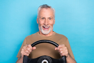 Poster - Close up photo of funny funky cheerful senior man pensioner impressed speed new own car test drive isolated on blue color background