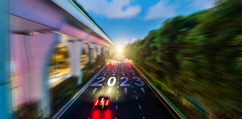 Wall Mural - Blurred motion of night traffic with new year number 2023, 2024 and 2025 on road