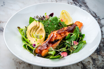 Sticker - Oven cooked salmon steak, fillet with avocado salsa and green on plate healthy food