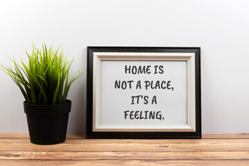 Wall Mural - Inspirational quotes text in a frame - home is not a place, it's a feeling.