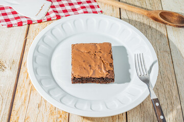 delicious homemade chocolate brownie over table with forkand dish plate. tasty chocolate dessert