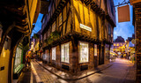 Fototapeta Uliczki - A Chirstmas night view of Shambles, a historic street in York featuring preserved medieval timber-framed buildings with jettied floors
