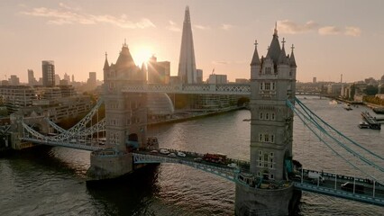 Fototapete - Iconic Tower Bridge at sunset. Connecting London with Southwark on the Thames River. Aerial sunset view of London city center and the Tower bridge of London. 