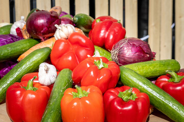 Fresh vegetables are piled up. Tomatoes, cucumbers, carrots, garlic, cabbage, red peppers and zucchini. Preparing to cook food. Lifestyle photo