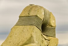 Closeup Of Stony Sculpture Bound With Ropes