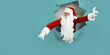 © ZaStock - Santa Clause peeking through a paper hole while gesturing hands. christmas advertisement concept
