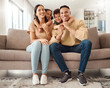 Hug, children and parents on the sofa in their living room for care, love and smile together in house. Portrait of happy, relax and young kids hugging mother and father with affection on the couch