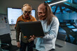 Two zombie businessmen looking at laptop screen