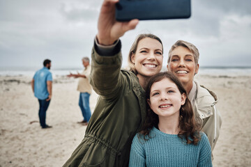 Canvas Print - Phone, selfie and beach with a girl, mother and grandmother taking a family photograph on the sand by the sea while on vacation. Summer, technology and love with female relatives posing for a picture