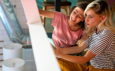 Wall Mural - Group of happy women friends having fun together. People technology social media concept.