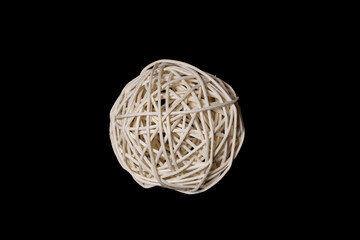 a ball woven from a wooden vine on a black background