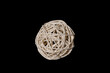 a ball woven from a wooden vine of bamboo on a black background