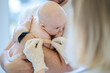 © zinkevych - Pediatrician carrying out a medical procedure on the neonate