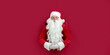 © ZaStock - Santa Clause peeks through a paper hole and waits christmas sale. christmas advertisement concept