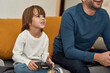 © Svitlana - Little boy and partial father playing video game