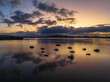 © Merrillie - Aerial sunrise waterscape with boats, rain clouds and reflections