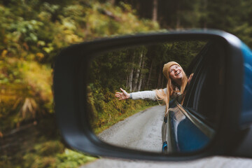 Wall Mural - Road trip woman traveling by rental car adventure lifestyle vacation vibes outdoor forest view mirror reflection freedom concept