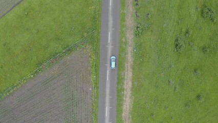 Sticker - Aerial drone view of a car riding on a road in highlands