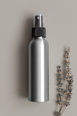 Sticker - Aluminium cosmetic spray bottle mockup with a lavender on the beige background.