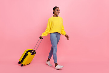 Wall Mural - Full length profile photo of pretty cheerful girl look empty space walk isolated on pink color background