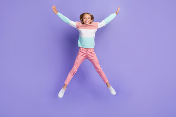 Poster - Full length photo of excited shiny little lady dressed sweatshirt jumping high like star isolated purple color background