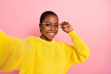 Wall Mural - Photo of positive cheerful lady make selfie arm touch eyeglasses isolated on pink color background