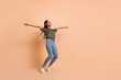 © deagreez - Full body portrait of positive pretty lady raise hands enjoy free time isolated on beige color background