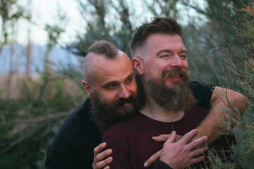 Sticker - Hipster gay couple having fun in nature. Long beard male homosexual partners laughing  outdoor. Candid photo.