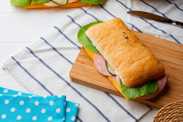 Wall Mural - Fresh sandwich with sausage and lettuce on table