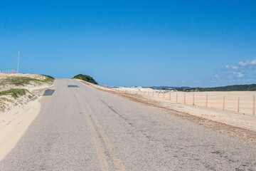 Wall Mural - street in the middle of the dunes desert in Genipabu