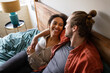 © ReeldealHD images - Young multiracial couple embracing in bedroom on vacation
