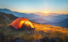 Tourist Tent Camping In Mountains At Sunset