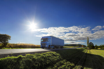 Truck transport on the road at sunset and cargo