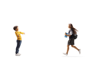 Poster - Full length profile shot of a schoolgirl running towards her little brother