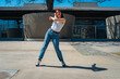© HC FOTOSTUDIO - Beautiful young latina dancing happily in the street while partying with jumps and somersaults. Concept of joy, street dance, hip hop.
