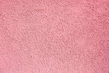Background Of Pink Concrete Wall. Decorative Embossed Concrete And Glue Plaster. Pink Plastered Wall. Plaster Textured Background. Blurred Photo