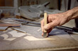 The carpenter's hand makes a mosaic of wood. Wood inlay. Handmade woodwork. Tools for woodworking.