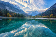 Jasna Lake In The Triglav National Park With Crystal Clear Water, Mountain Peaks And Blue Sky With Clouds, Amazing Autumn Landscape, Outdoor Travel Background, Kranjska Gora, Slovenia