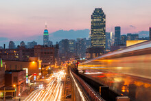 New York View At Sunset With Blurred Metro Train, Busy Roads And Manhattan Skyline