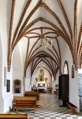 Wall Mural - Aisle of St. John Evangelist church Kosciol Sw. Jana Ewangelisty in historic old town center of Bartoszyce in Poland