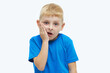 © oes - Portrait of a surprised upset boy in a blue t-shirt on a white background