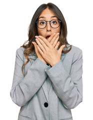 Wall Mural - Young brunette woman wearing business clothes shocked covering mouth with hands for mistake. secret concept.