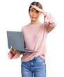 © Krakenimages.com - Beautiful caucasian woman with blonde hair working using computer laptop stressed and frustrated with hand on head, surprised and angry face