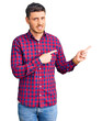 © Krakenimages.com - Handsome young man with bear wearing casual shirt pointing aside worried and nervous with both hands, concerned and surprised expression
