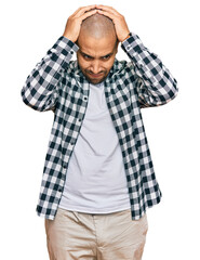 Canvas Print - Hispanic adult man wearing casual clothes suffering from headache desperate and stressed because pain and migraine. hands on head.