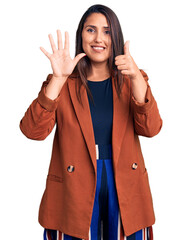 Sticker - Young beautiful brunette woman wearing elegant clothes showing and pointing up with fingers number six while smiling confident and happy.