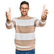 © Krakenimages.com - Handsome man with beard wearing casual clothes and glasses looking at the camera smiling with open arms for hug. cheerful expression embracing happiness.
